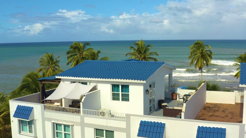 Aerial view of the penthouse rooftop, terrace, palms and Atlantic shoreline